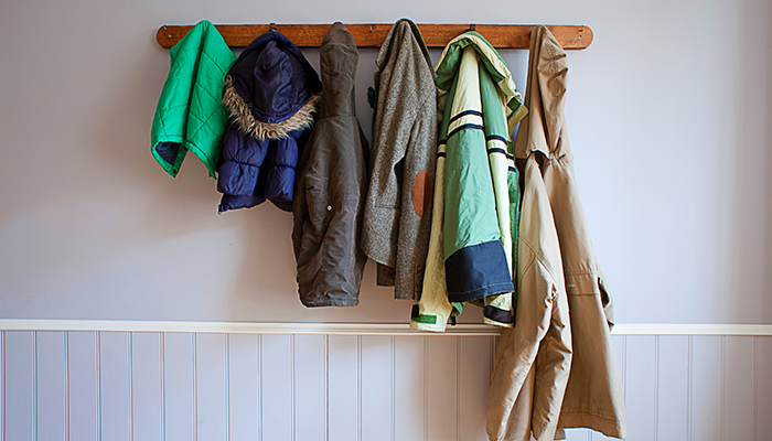 Coat rack with different types of coats on it